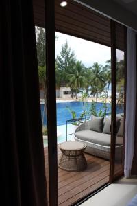 a room with a couch and a view of the ocean at Dahican Beach Resort and Spa in Sampong