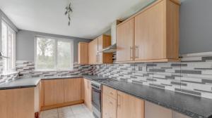 a kitchen with wooden cabinets and a stove top oven at Cosy Home Contractors, Relocations, Coffee Machine in Beoley
