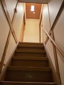 a flight of stairs in a building at 耀来YoRaiようらい in Nagaokakyo