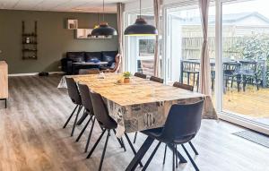 a dining room with a table and some chairs at Awesome Home In Thyborøn With Wifi in Thyborøn +13 photos
