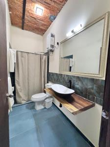 a bathroom with a sink and a toilet and a mirror at Casa Tlaquepaque in Guadalajara +36 photos