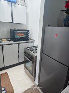 a kitchen with a refrigerator and a microwave at studio in Abu Dhabi