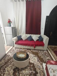 a living room with a couch and a table at studio in Abu Dhabi