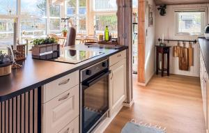 a kitchen with a stove and a counter top at St Croix in Hadsund