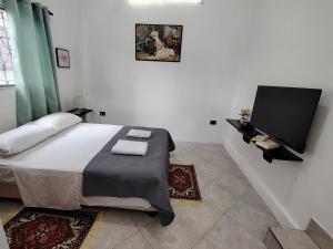 a bedroom with a bed and a flat screen tv at Galápagos Islands-Apartment in Santa Cruz in Puerto Ayora