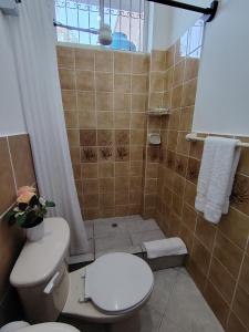 a bathroom with a toilet and a shower at Galápagos Islands-Apartment in Santa Cruz in Puerto Ayora