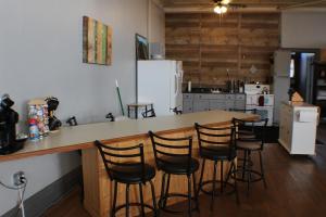a kitchen with a bar with stools around it at Kaleva East in South Range