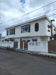 a white house with two bikes parked in front of it at Galápagos Islands-Apartment in Santa Cruz in Puerto Ayora