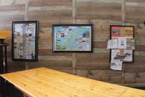 a wall with a wooden table and pictures on it at Kaleva East in South Range