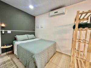 a bedroom with a bed and a ladder in it at Loft 967 in Itajaí
