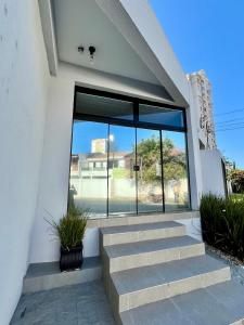 a building with stairs and a large window at Loft 967 in Itajaí