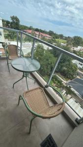 a table and chair on a balcony with a view at Depto Yrigoyen, opcional COCHERA a 20 metros in Rafaela