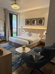 a bedroom with a bed and a table and chairs at The Lemiray Hotel in Dodoma
