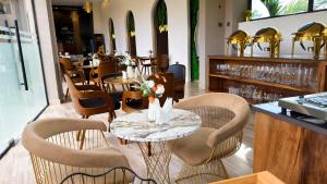 a restaurant with a table and chairs and a bar at The Lemiray Hotel in Dodoma