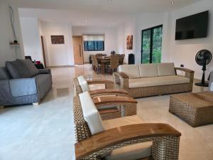 a living room with couches and a dining room at Casa Mezcal in Villeta