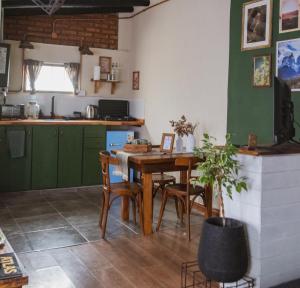a kitchen with a table and chairs in a room at Aware in Capilla del Monte +13 photos