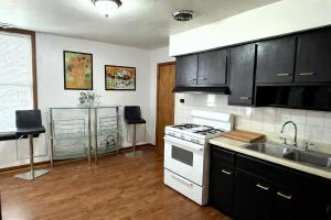 a kitchen with a white stove and a sink at Location! Location! 2bd 1bth spacious apartment! in Chicago +15 photos