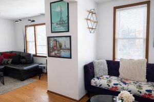 a living room with a couch and a chair at Location! Location! 2bd 1bth spacious apartment! in Chicago