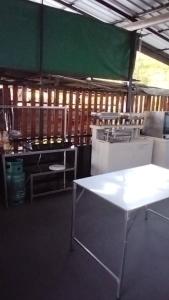 a kitchen with a white table and a green wall at Crowd free own pace and space in Rayong in Ban Chak Khamin +11 photos