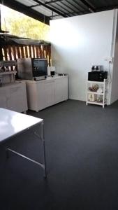 a room with a kitchen with a tv and a table at Crowd free own pace and space in Rayong in Ban Chak Khamin