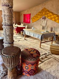 a room with a bed and a table and a room with a table at Riad Dar Zaouia in Zagora