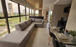 a living room with a couch and a table at Reserva Madero Loft in Natal