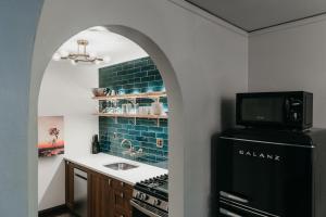 a kitchen with a black refrigerator and a sink at The Wilson in Madison