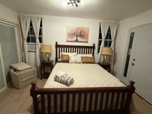 a large bed in a bedroom with two windows at Crema queen in Decatur