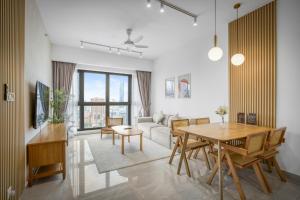 a living room with a table and a couch at Cavera Bukit Bintang in Kuala Lumpur
