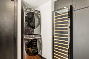 two washers and a dryer in a room at The Hideaway Big Bear in Big Bear Lake
