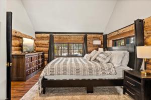 a bedroom with a bed and a wooden wall at The Hideaway Big Bear in Big Bear Lake