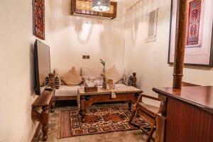 a living room with a couch and a table at بوتيك خان عطره in Medina