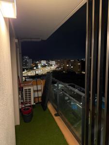 a balcony with a view of a city at night at Grand Studio Neuf in Ajaccio