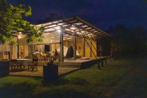 a house with a lit up patio at night at Panthera Lodge Yala in Kirinda