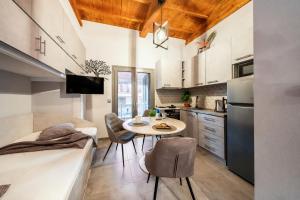 a kitchen with a table and chairs in a room at Oniro Living - Skra 10 in Mytilene