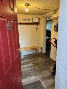 a door to a waiting room with a bench on the wall at Alaska Tucked Inn in Fairbanks