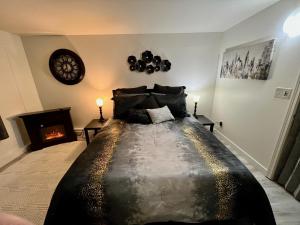 a bedroom with a large bed and a fireplace at Alaska Tucked Inn in Fairbanks +117 photos