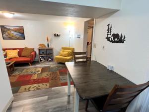 a living room with a table and a couch at Alaska Tucked Inn in Fairbanks