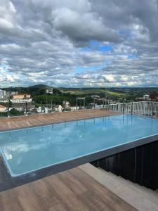 a large swimming pool on the roof of a building at Apartamento Studio in Barbacena