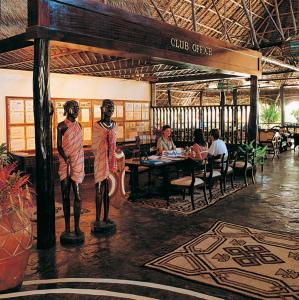 a painting of two man statues in a restaurant at Blue Bay Village in Watamu