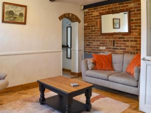a living room with a couch and a table at Why Not in Canterbury