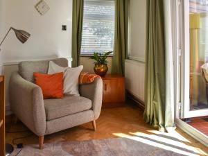 a living room with a chair and a window at Why Not in Canterbury +20 photos