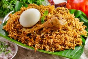 a green plate of rice with an egg on it at HALASE HOMESTAY mudigere in Mudigere +26 photos