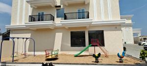 a house with a playground in front of it at Leaf Hotel in Tiruvannāmalai