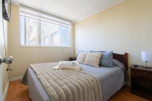 a bedroom with a bed and a window at Alta vista Concepción in Concepción +29 photos