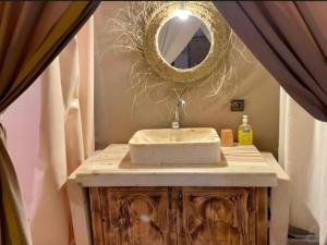 a bathroom with a sink and a mirror at Merzouga Traditional Camp in Merzouga +47 photos