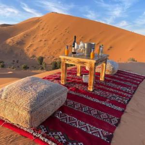 a table in the middle of a desert with at Merzouga Traditional Camp in Merzouga