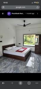 a bedroom with a large bed in a room at Poozhikuth Homestay in Sultan Bathery +5 photos
