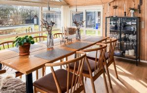 a dining room with a wooden table and chairs at St Croix in Hadsund