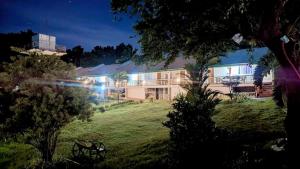 a building with lights on in a yard at night at Harmony Place at Hillside in Puerto Princesa City